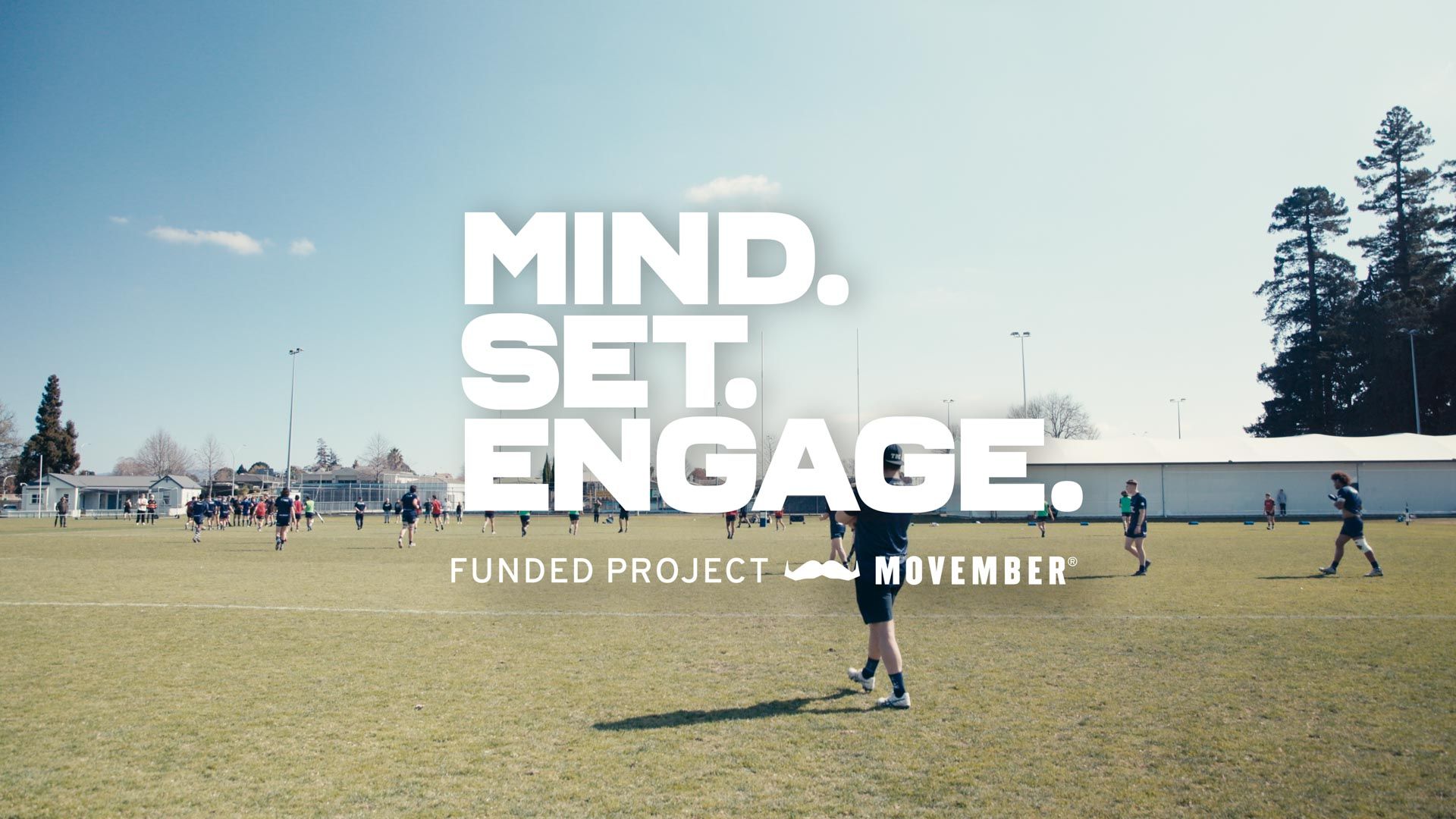 A photo of rugby players on an oval. Superimposed text reads: "Mind. Set. Engage."