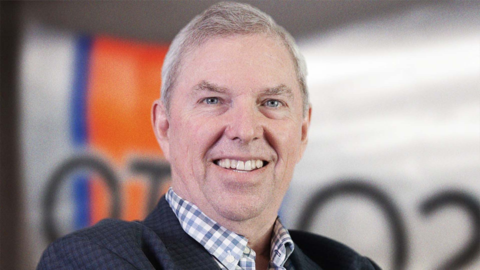 Portrait photo of John Carswell smiling to camera.