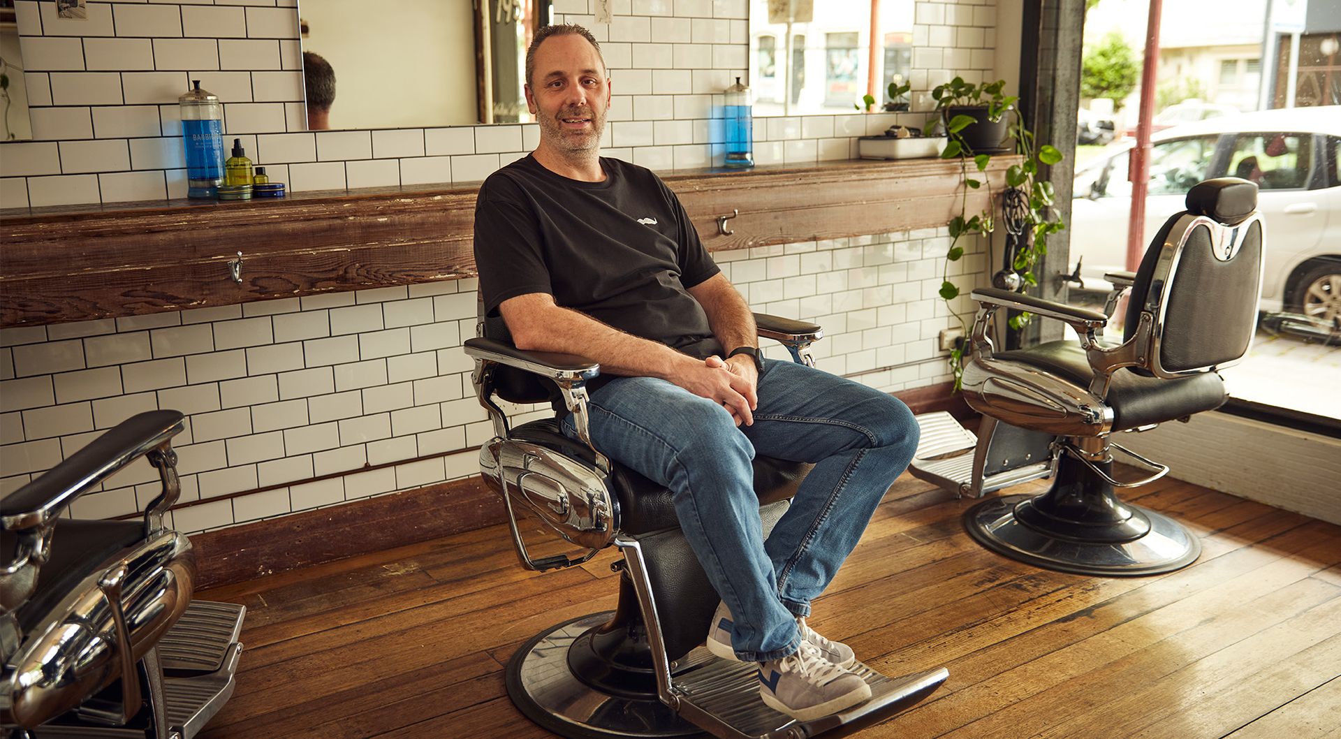 Mo Bro Bradley sits in the barber chair