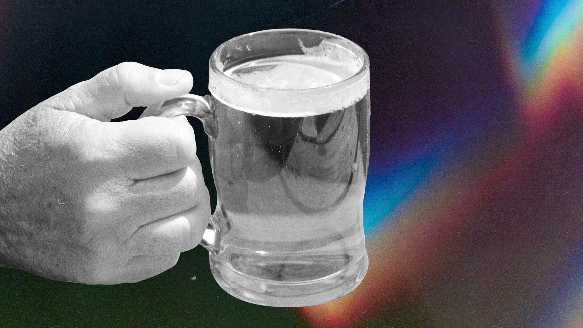 A close-up photo of a hand holding a beer.