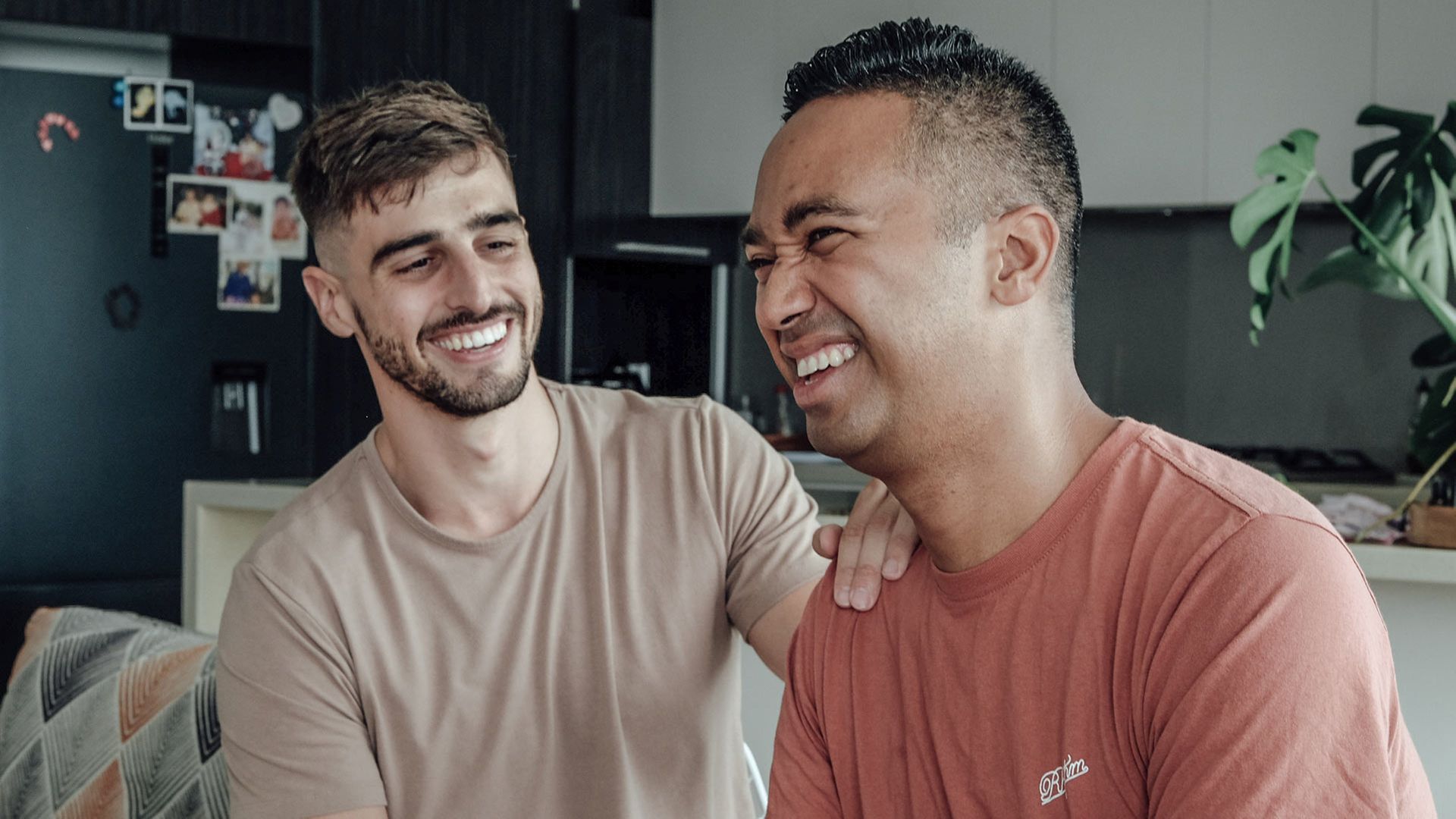 Photo of two men laughing.
