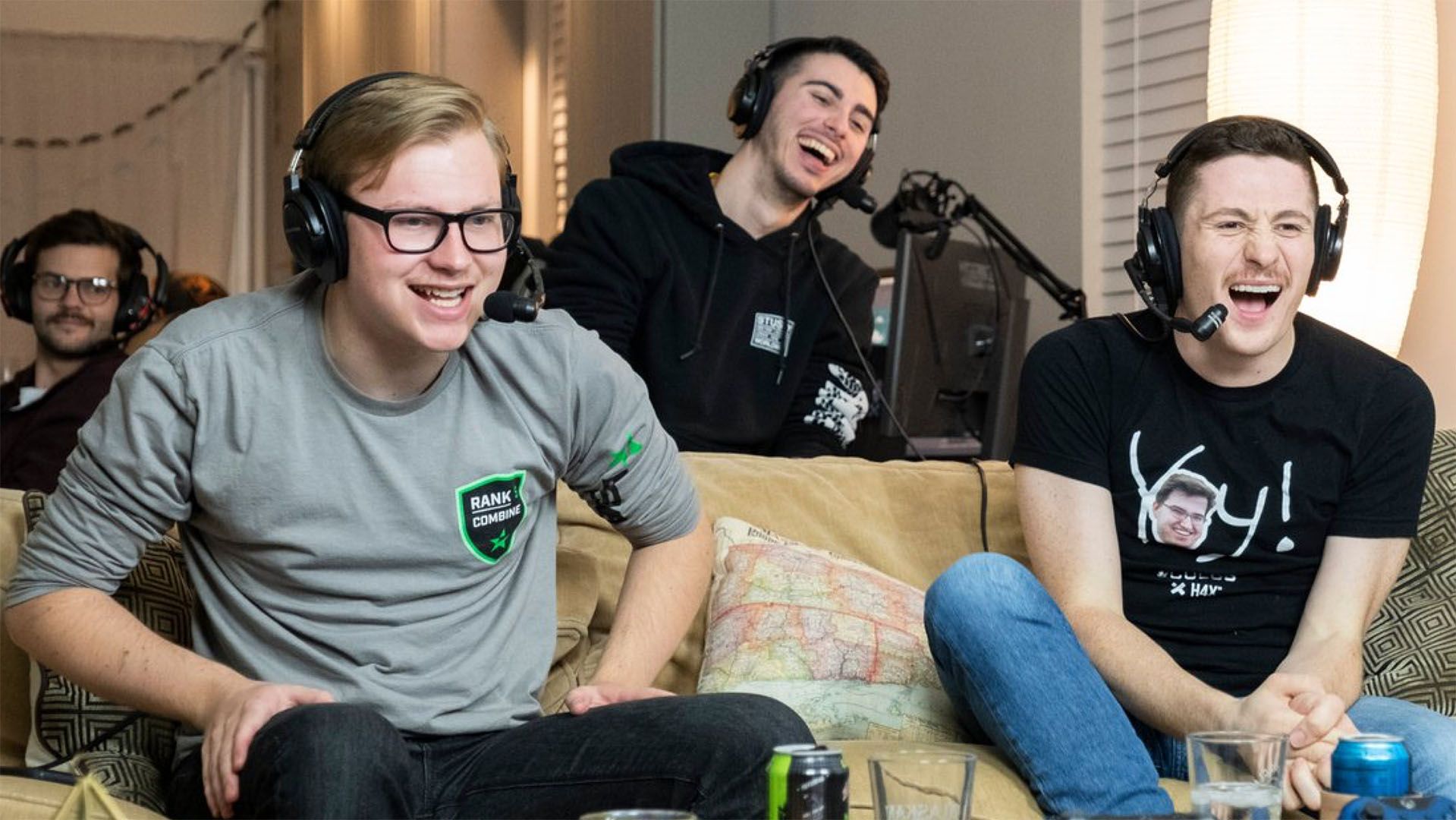 Photo of excited gamers on a couch, enthusiastically getting into a live stream for Movember.
