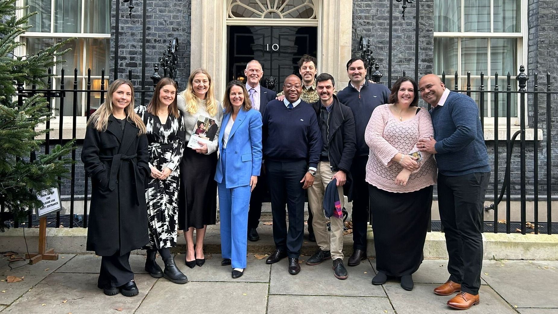 Photo of Movember ambassadors, partners, and staff outside 10 Downing Street.