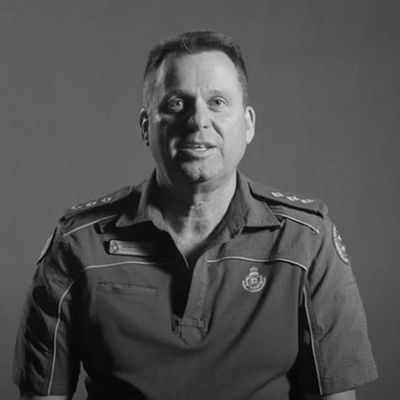 Black and white portrait photo of veteran paramedic looking to camera.