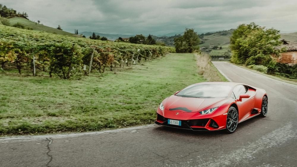 A Lamborghini with a moustache sticker on the bonnet 