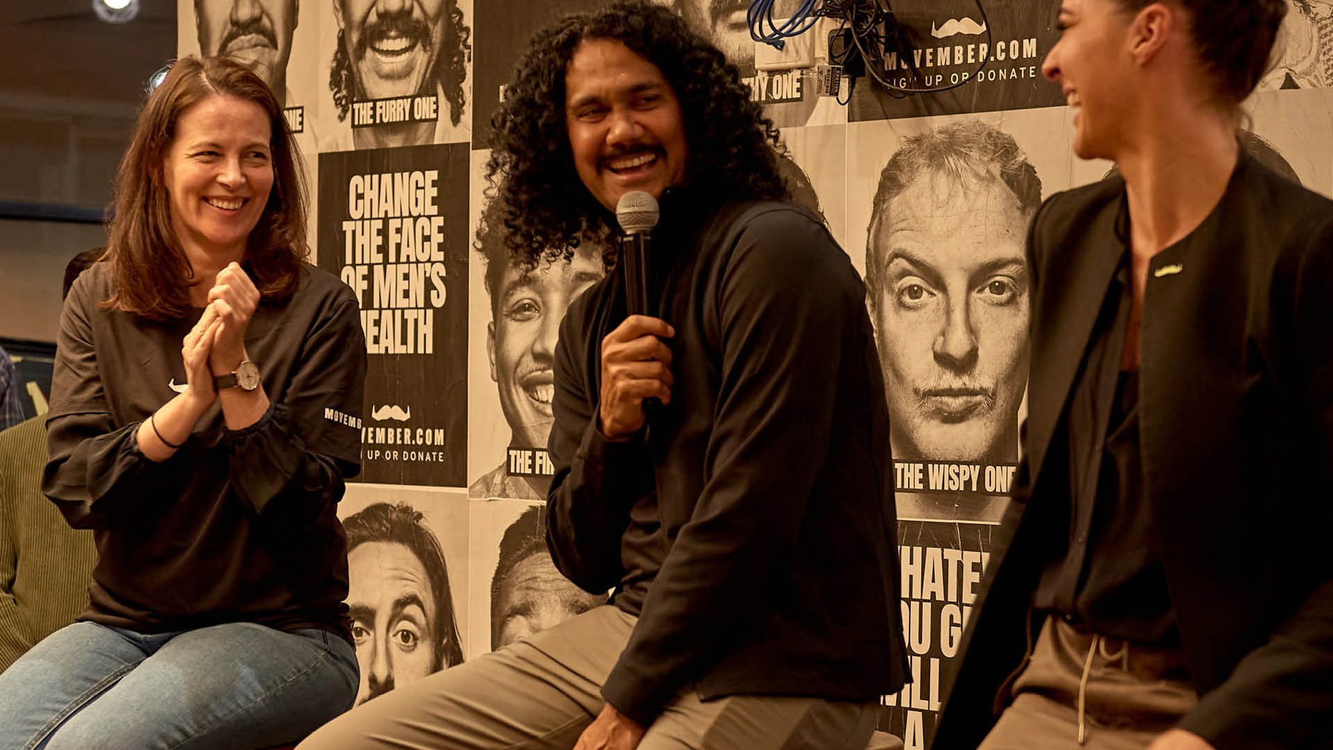 Photo of three people on a panel discussing men's health