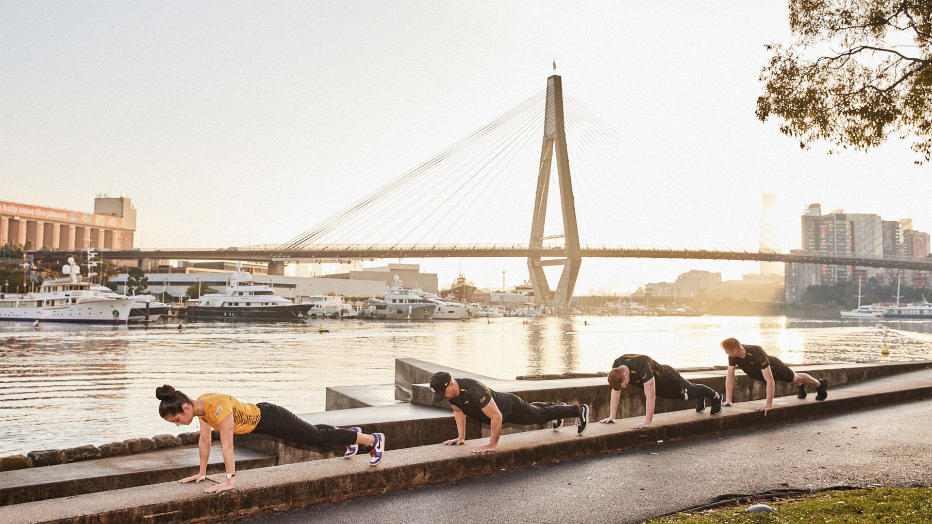 Mo Sister Serena and her team push-up by the water in Sydney harbour.