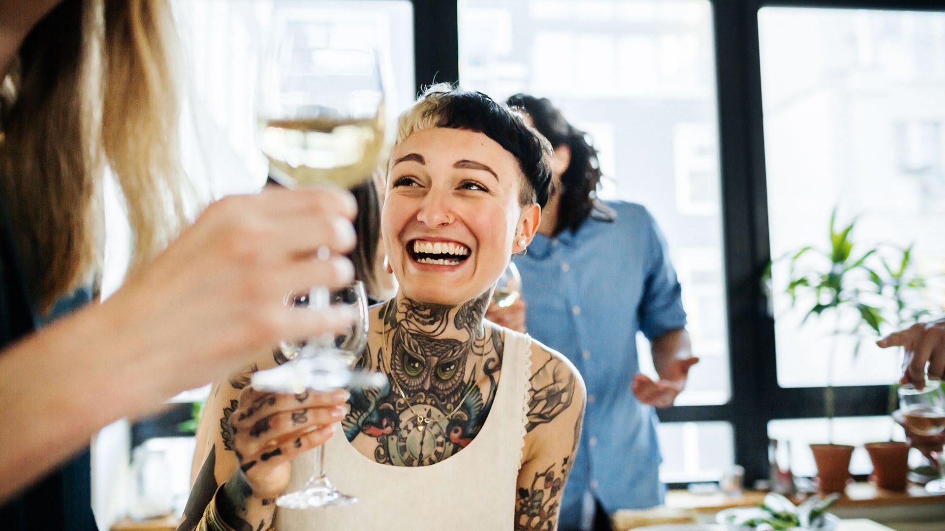 Two young people charging their glasses in a toast.