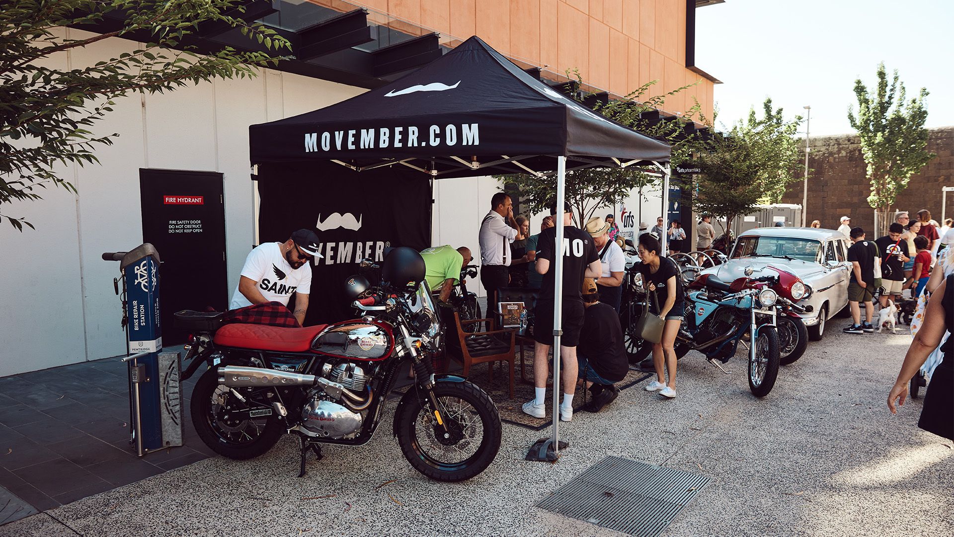 Movember marquee with multiple motorcycles at a market in Melbourne.