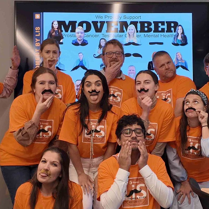 Photo of a group of Movember supporters posing for a group shot.