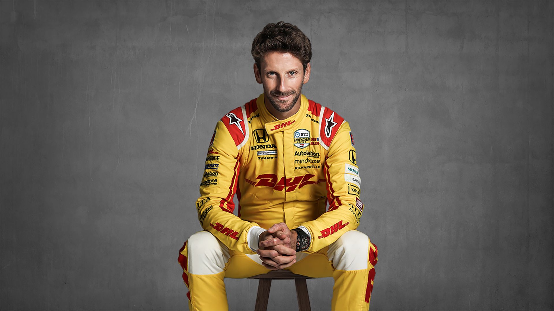 Indy Race Car Driver Romain Grosjean poses for a portrait in his bright yellow DHL Express racing suit